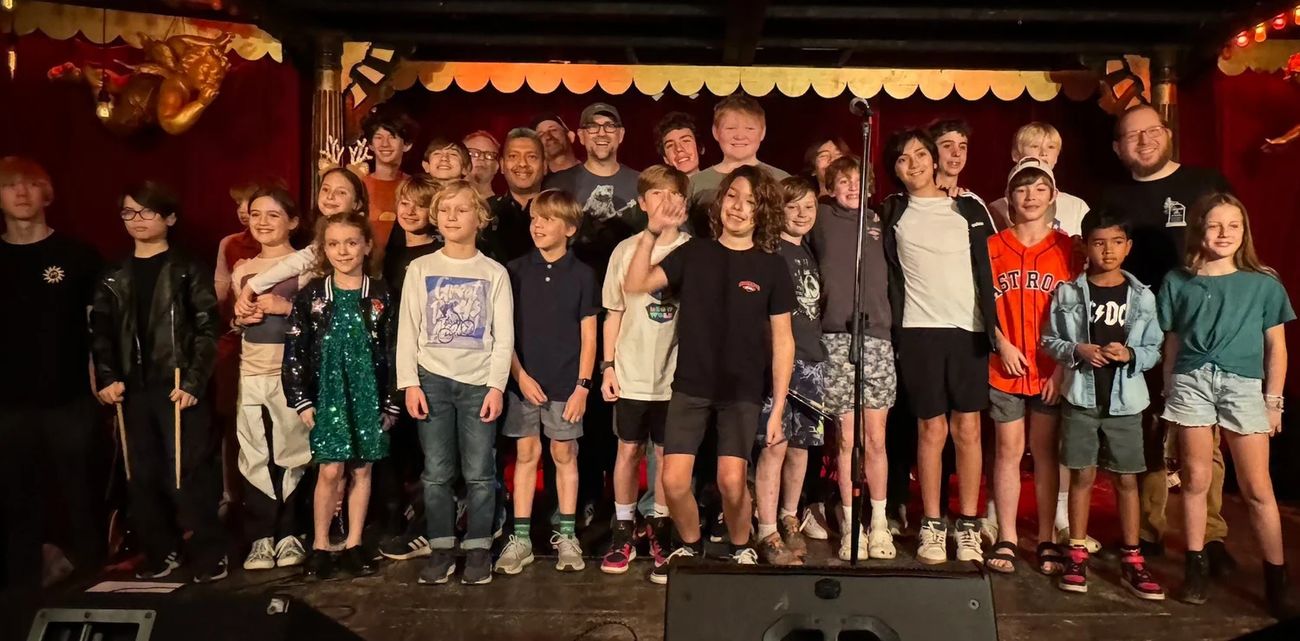 Drum Lessons Austin students and teachers together on stage at a student show